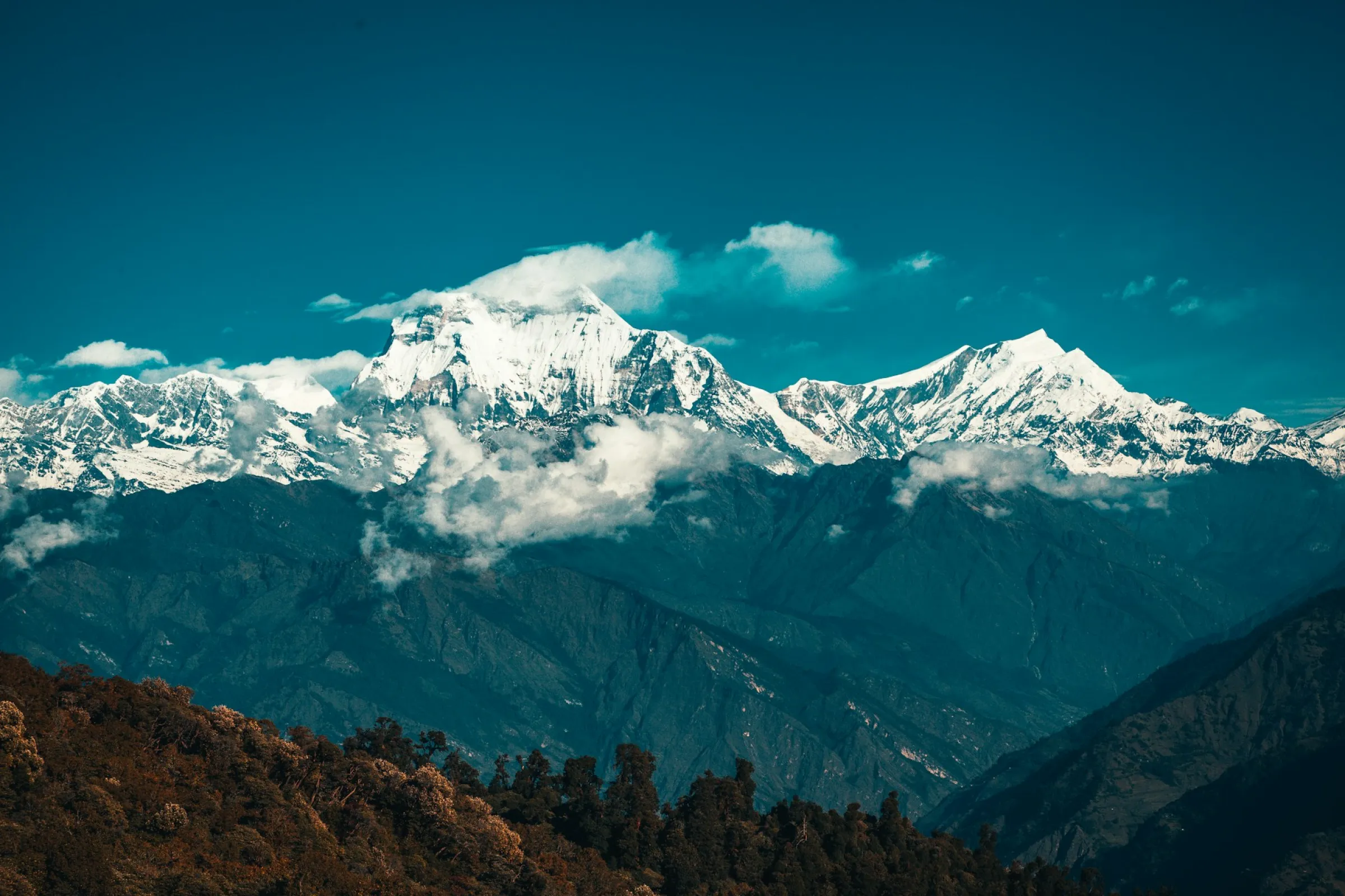 Snow-capped Himalayan peaks with dramatic mountain valleys